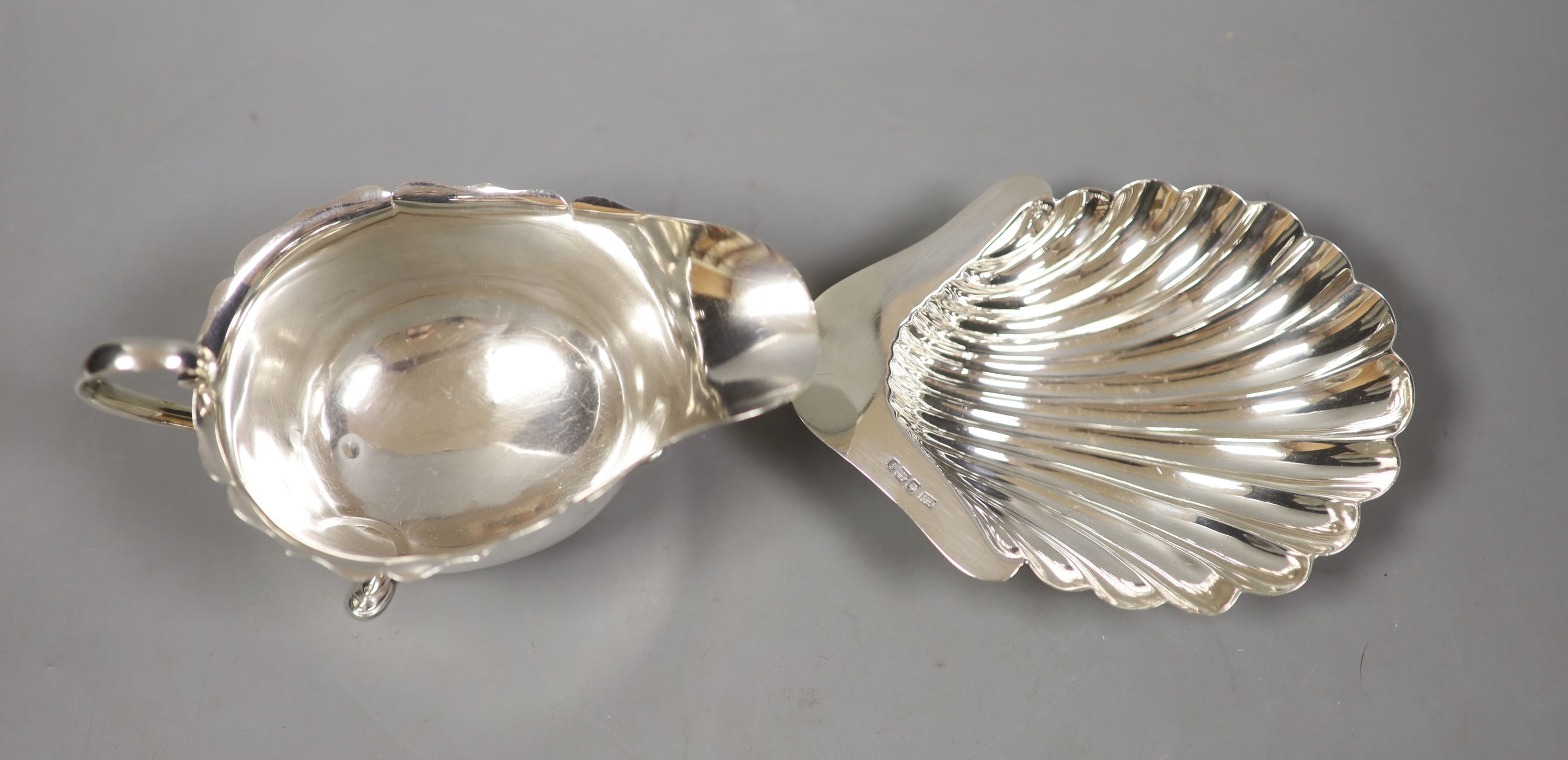 A George V silver butter shell, 13.2cm and a similar sauceboat by Mappin & Webb